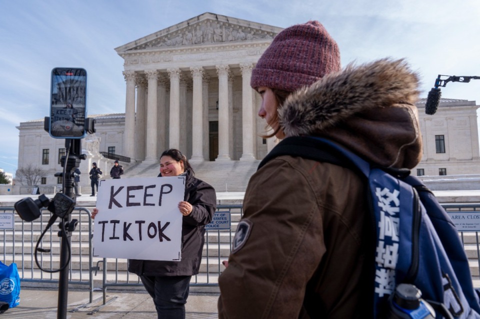 <strong>Callie Goodwin, of Columbia, S.C., holds a sign in support of TikTok outside the Supreme Court, Friday, Jan. 10, 2025, in Washington. Goodwin, a small business owner who sells personalized greeting cards, says 80% of her sales come from people who found her on TikTok.</strong> (Jacquelyn Martin/AP)