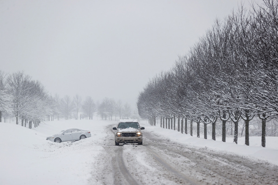 <strong>A car sits in a ditch on snow-covered Farm Road at Shelby Farms on Friday, Jan. 10.</strong> (Mark Weber/The Daily Memphian)