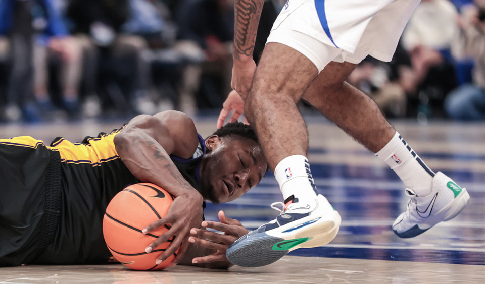 <strong>ECU guard RJ Felton (3) dives for a loose ball during Saturday&rsquo;s game against Memphis.</strong>&nbsp;T<strong>he Tigers edged the Pirates 74-70.</strong> (Patrick Lantrip/The Daily Memphian)