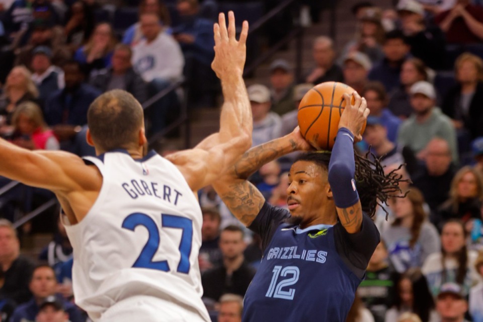 <strong>Memphis Grizzlies guard Ja Morant (12) looks to pass the ball past the defense of Minnesota Timberwolves center Rudy Gobert (27) in the first quarter of an NBA basketball game Saturday, Jan. 11, 2025, in Minneapolis.</strong> (Bruce Kluckhohn/AP)