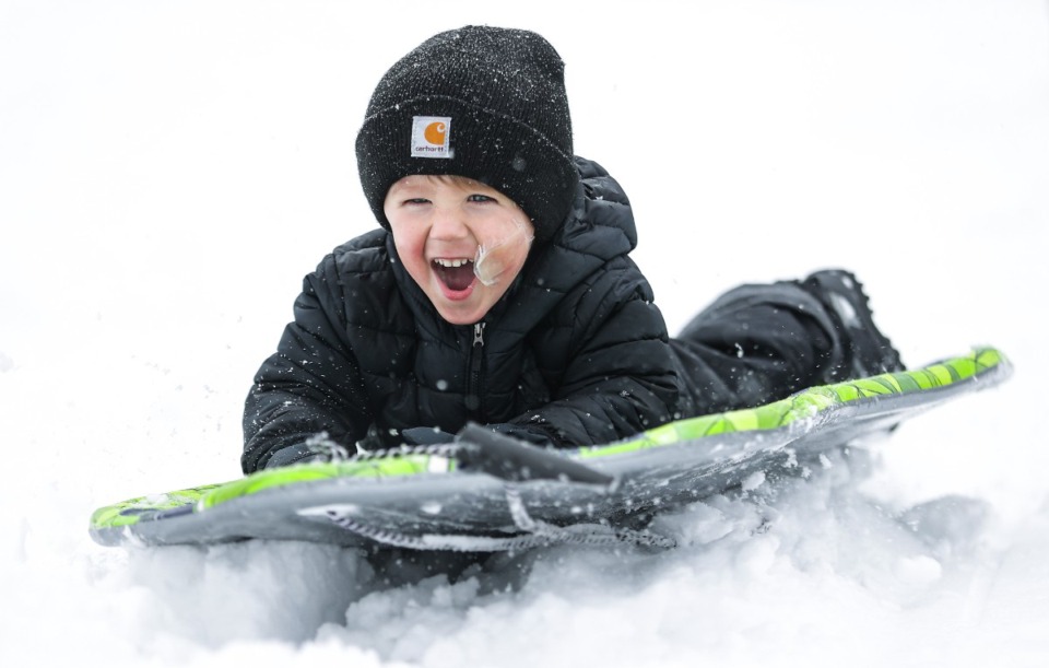 <strong>Theo Melford, 2, laughs while sledding down the hill at the Overton Park Shell Jan. 10, 2025.</strong> (Patrick Lantrip/The Daily Memphian)