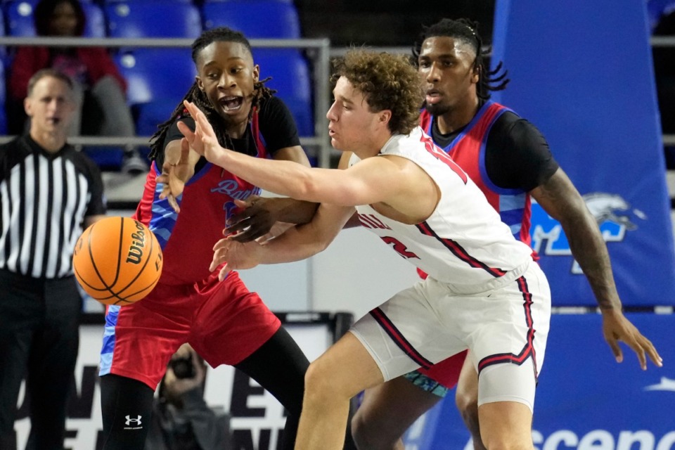 <strong>Bartlett&rsquo;s Axton Perry, left, and R'chaun King, right, defend against Cookeville guard Jaren Davis (12) during the first half of a Class 4A basketball game Friday, March 15, 2024, in Murfreesboro, Tenn.</strong> (Mark Humphrey/Special to The Daily Memphian file)