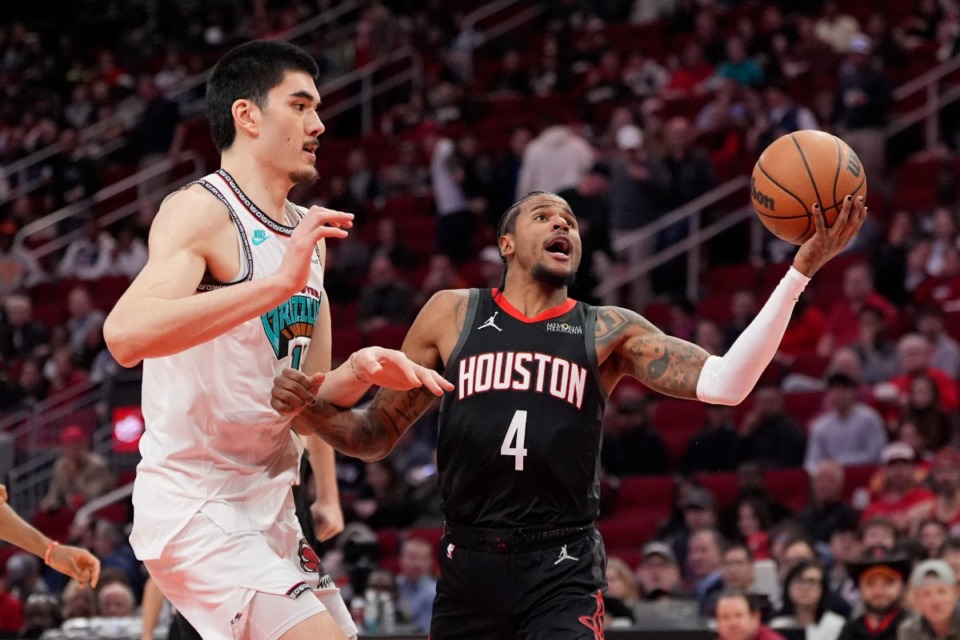 <strong>Houston Rockets' Jalen Green (4) goes up for a shot as Memphis Grizzlies' Zach Edey defends during the first half of an NBA basketball game Monday, Jan. 13, 2025, in Houston.</strong> (AP Photo/David J. Phillip)