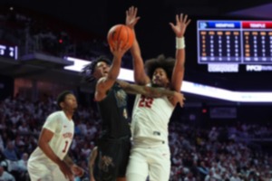 <strong>Memphis' PJ Haggerty (4) goes up for a shot between Temple's Elijah Gray (22) and Zion Stanford (1) during the first half of an NCAA college basketball game, Thursday, Jan. 16, 2025, in Philadelphia.</strong> (AP Photo/Matt Slocum)