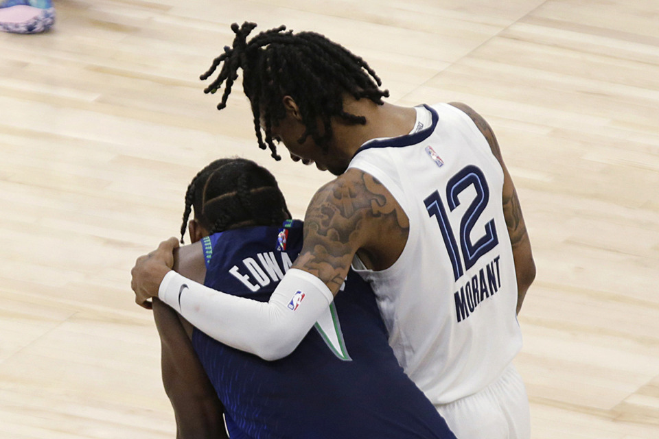 <strong>Memphis Grizzlies guard Ja Morant (12) consoles Minnesota Timberwolves forward Anthony Edwards (1) late in the second half of Game 6 in an NBA basketball first-round playoff series April 29, 2022, in Minneapolis.</strong> (Andy Clayton-King/AP file)