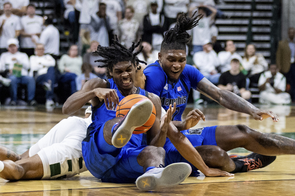 <strong>Memphis guard PJ Carter (7) gets the ball away from Charlotte guard Ben Bradford, blocked, during the first half of an NCAA college basketball game on Sunday, Jan. 19, 2025, in Charlotte, N.C.</strong> (Scott Kinser/AP Photo)