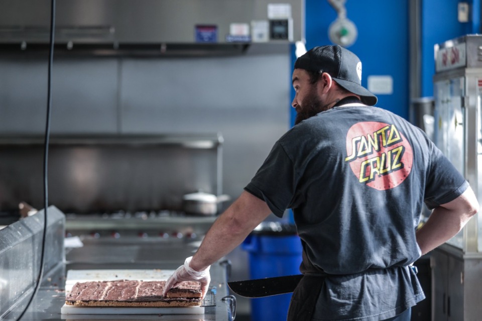 <strong>Sonny Linn cuts up rice crispy treats at Amplified Meal Prep Jan. 17, 2025.</strong> (Patrick Lantrip/The Daily Memphian)