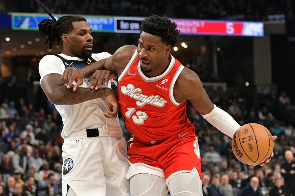 <strong>Memphis Grizzlies forward Jaren Jackson Jr. (13) handles the ball against Minnesota Timberwolves center Naz Reid in the first half of an NBA basketball game Monday, Jan. 20, 2025, in Memphis.</strong> (Brandon Dill/AP)