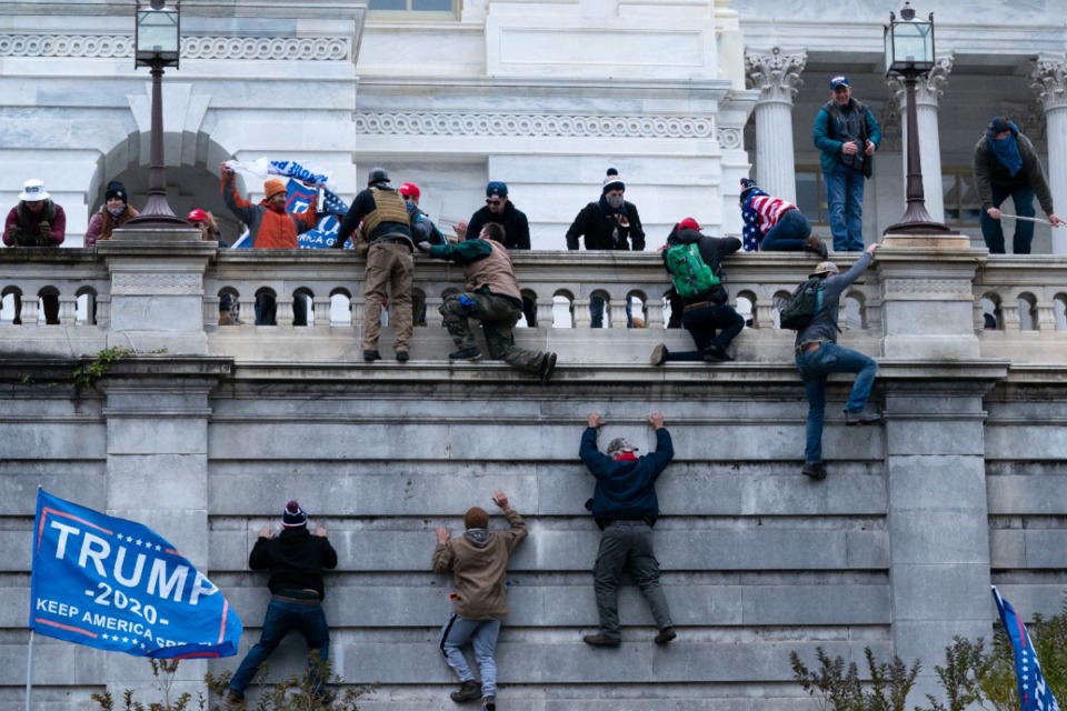 <strong>Supporters of Pres. Donald Trump climb the west wall of the U.S. Capitol on Wednesday, Jan. 6, 2021, in Washington. Trump pardoned roughly 1,500 of the rioters on his first day back in office.</strong> (Jose Luis Magana/AP)