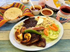 <strong>The costilla de res con camar&oacute;n is a platter meant to be shared. It comes with rib steaks, grilled shrimp and sides: spiced rice, black beans, iceberg lettuce with lime and tomato and macaroni salad. The plate also comes with warm tortillas and fresh salsa roja.</strong>&nbsp;(Joshua Carlucci/Special to The Daily Memphian)