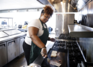 <strong>Shroomlicious owner Daishu McGriff makes one of her Black Restaurant Week specials, an Impossible burger, on March 7, 2022.</strong> (Mark Weber/The Daily Memphian file)