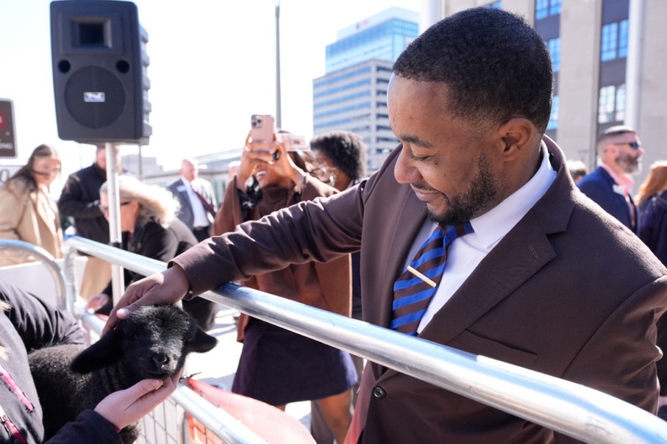 <strong>Democratic Rep. Jesse Chism pets a lamb during Agriculture Day on the Hill outside the capitol Tuesday, March 19, 2024, in Nashville.</strong> (George Walker IV/AP file)