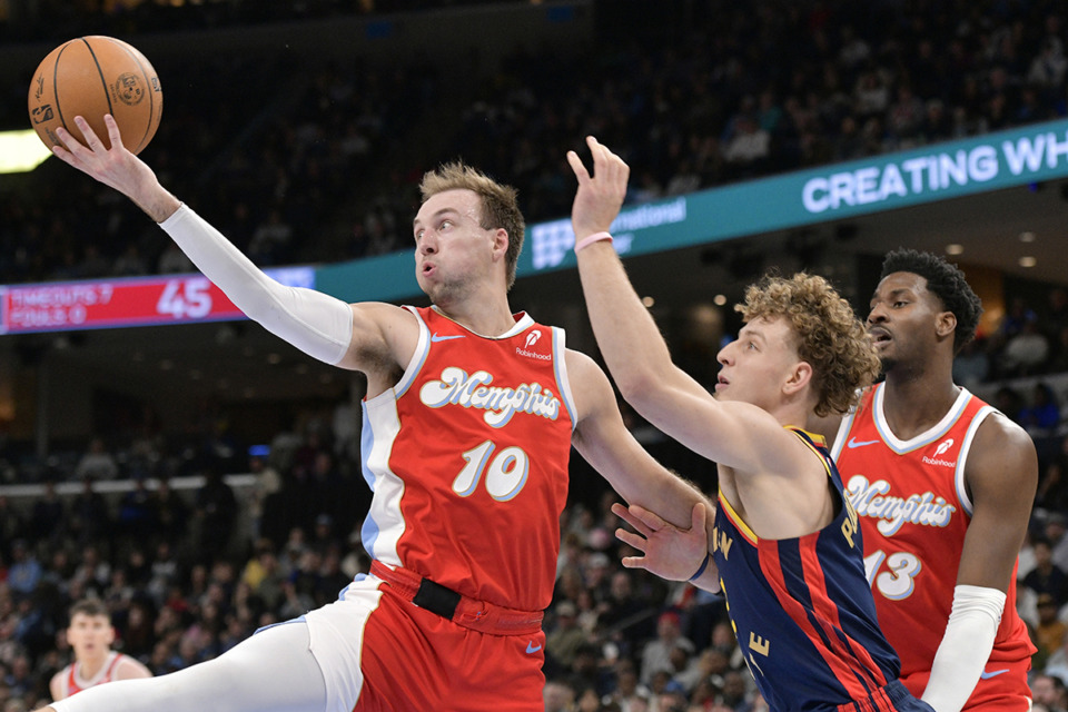 <strong>Memphis Grizzlies guard Luke Kennard (10) shoots ahead of Golden State Warriors guard Brandin Podziemski (2) in the first half of an NBA basketball game Thursday, Dec. 19, 2024, in Memphis.</strong> (Brandon Dill/AP Photo file)