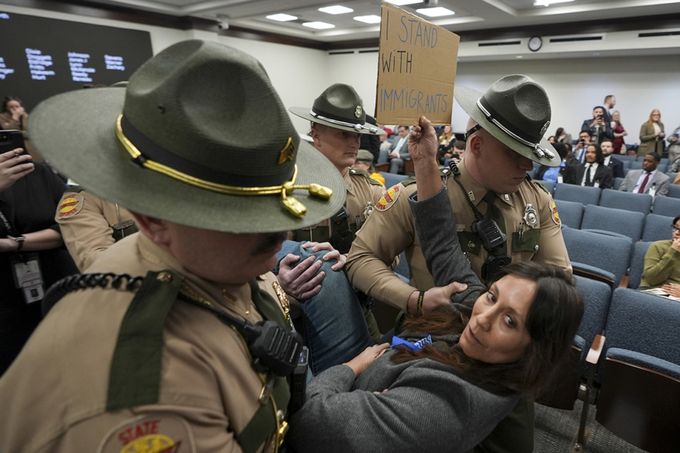 <strong>Ashley Warbington is removed from a House committee meeting on immigration by State Troopers during a special session of the Legislature Wednesday, Jan. 29, 2025, in Nashville.</strong> (George Walker IV/AP Photo)