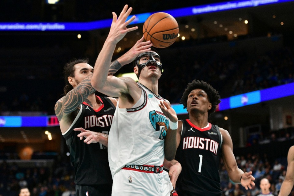 <strong>Memphis Grizzlies center Zach Edey</strong> <strong>(14) struggles for control of the ball between Houston Rockets center Steven Adams, left, and forward Amen Thompson (1) on Thursday, Jan. 30, 2025.</strong> (Brandon Dill/AP)