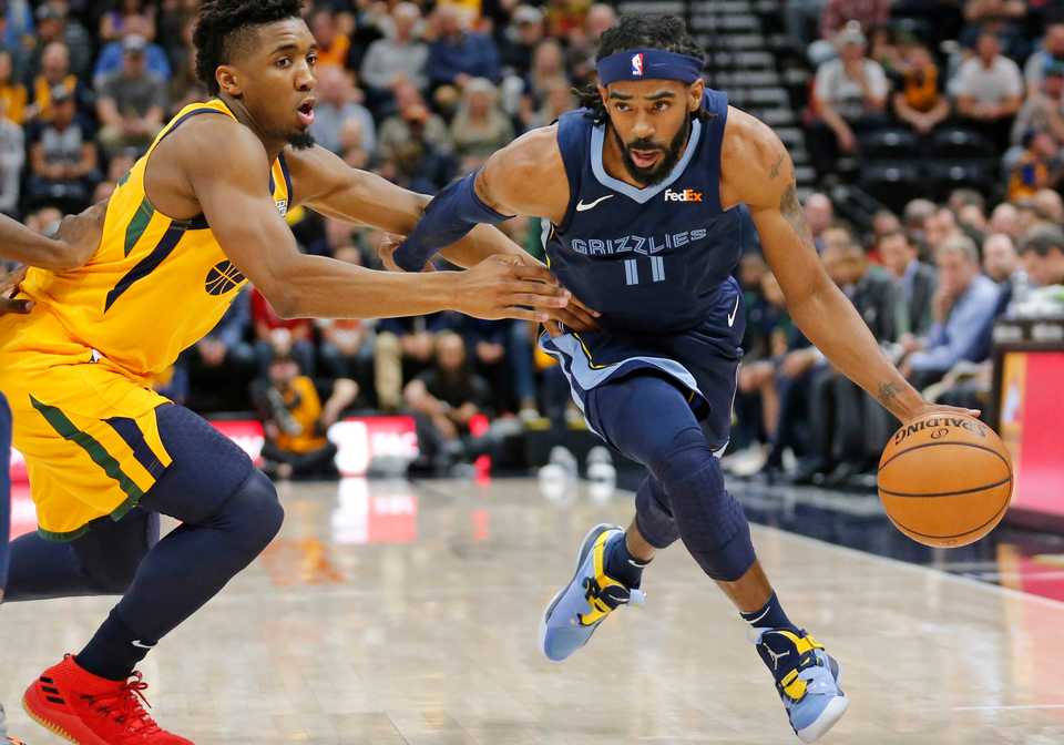 Memphis Grizzlies guard Mike Conley (11) drives around Utah Jazz guard Donovan Mitchell, left, in the first half of an NBA basketball game Monday, Oct. 22, 2018, in Salt Lake City. (AP Photo/Rick Bowmer)