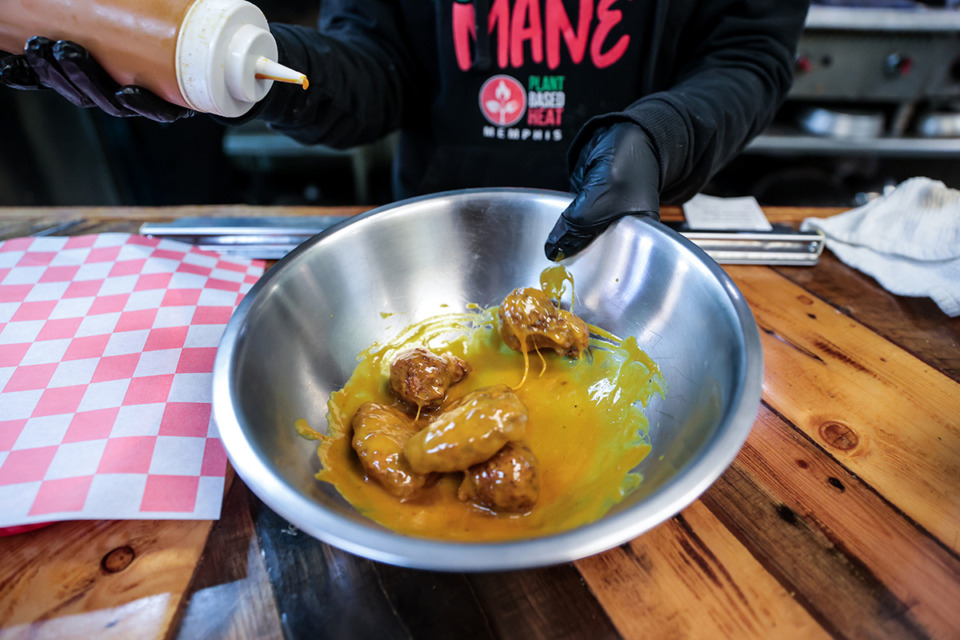 <strong>Jasmin Smith prepares an order of vegan wings from Plant-Based Heat near the University of Memphis on Jan. 28.</strong> (Patrick Lantrip/The Daily Memphian)