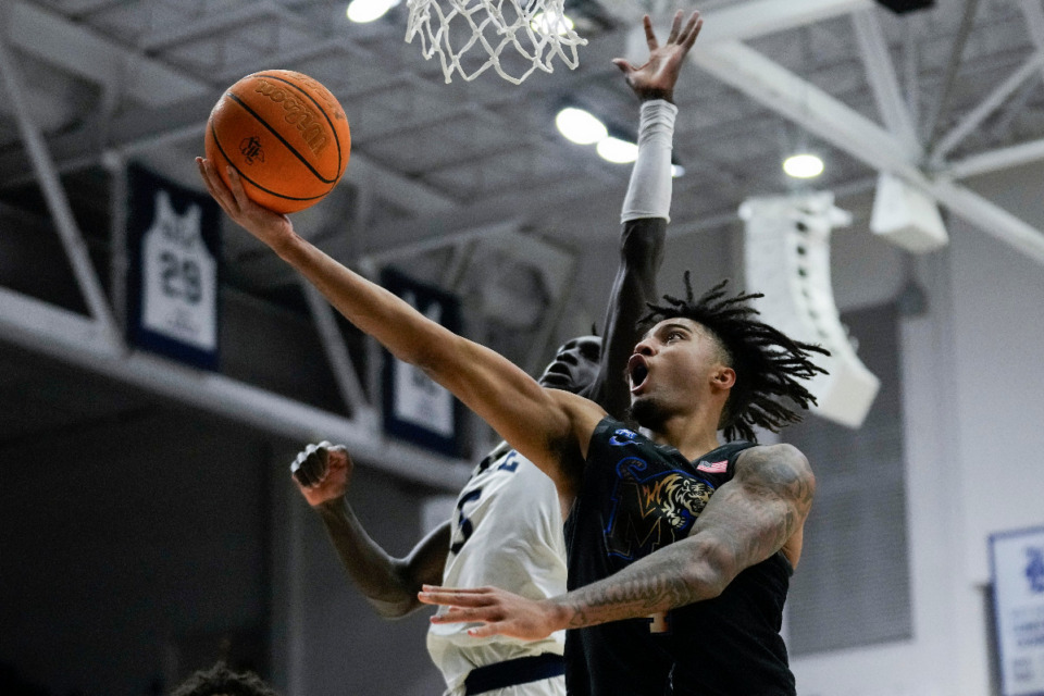 <strong>Memphis guard PJ Haggerty (4) shoots against Rice guard Jacob Dar (5) during the first half of an NCAA college basketball game in Houston, Sunday, Feb. 2, 2025.</strong> (AP Photo/Ashley Landis)