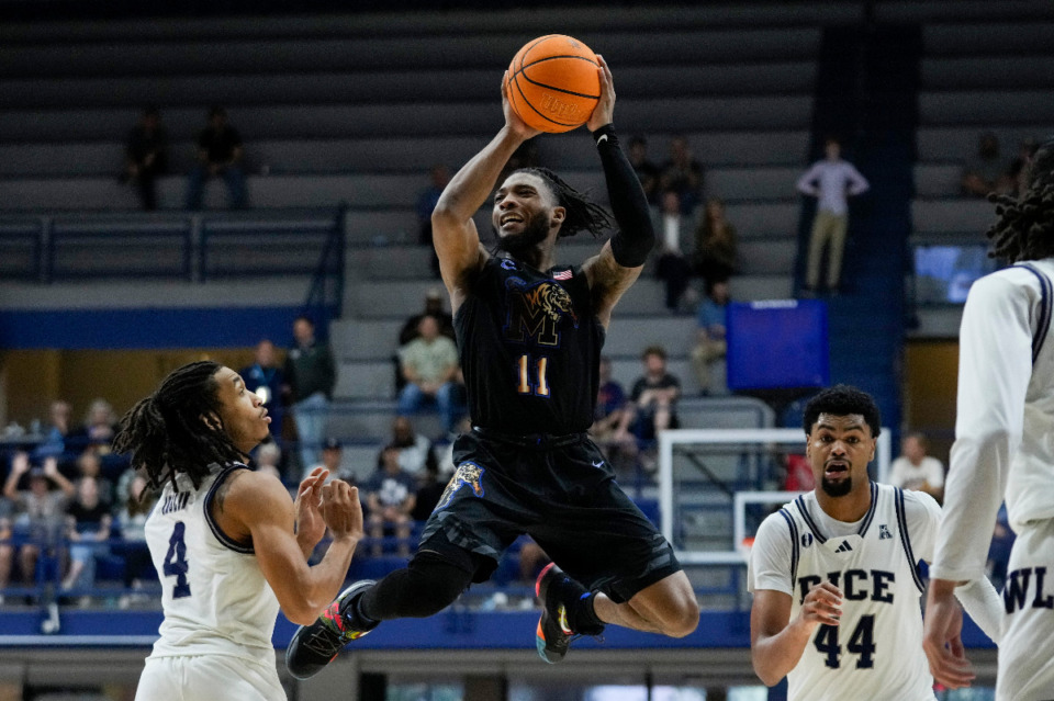 <strong>Memphis guard Tyrese Hunter (11) passes during the second half of an NCAA college basketball game against Rice in Houston, Sunday, Feb. 2, 2025.</strong> (AP Photo/Ashley Landis)