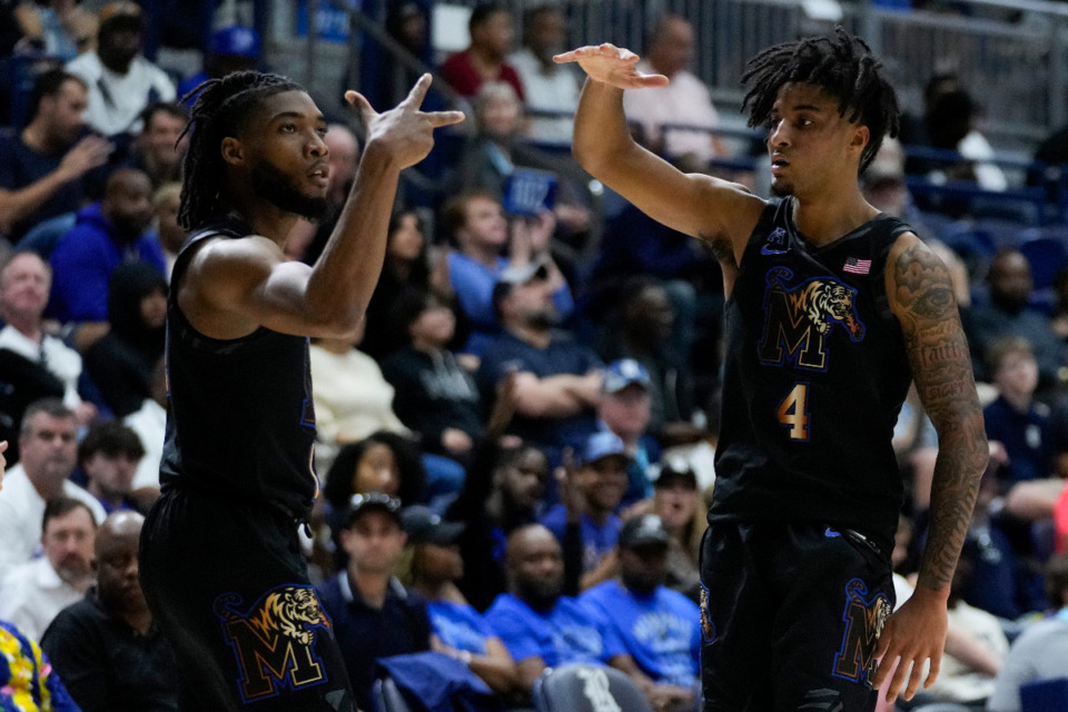 <strong>Memphis guard Tyrese Hunter, left, celebrates with guard PJ Haggerty (4) after making a 3-pointer during the second half of an NCAA college basketball game against Rice in Houston, Sunday, Feb. 2, 2025.</strong> (AP Photo/Ashley Landis)