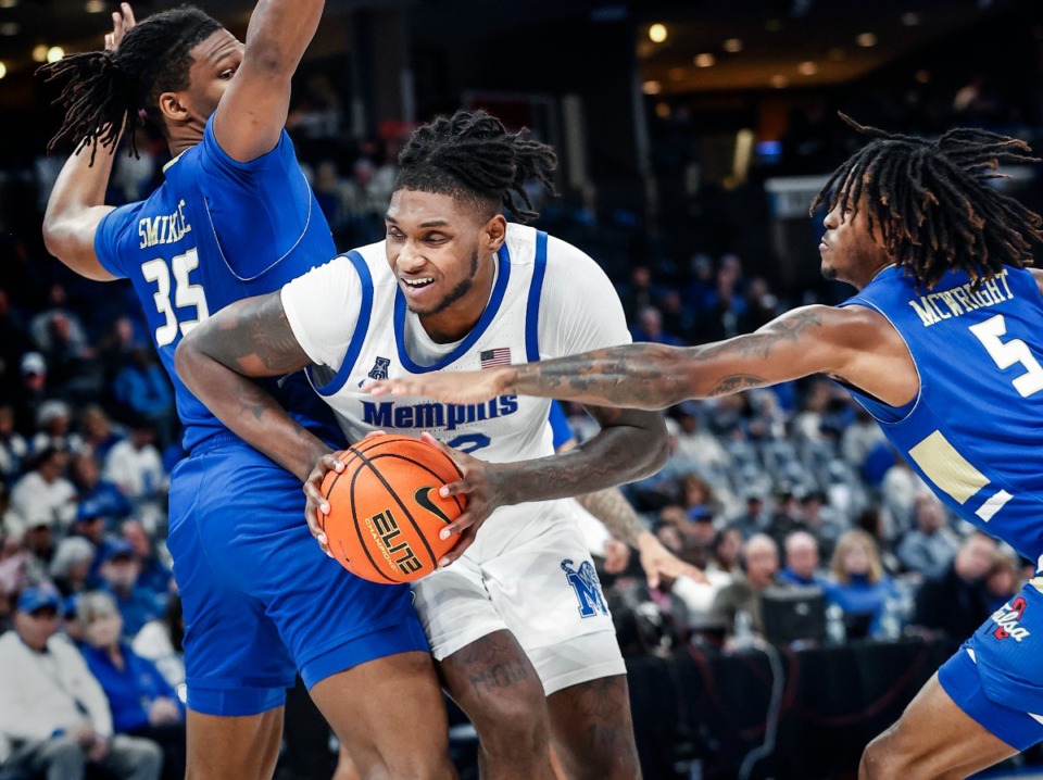 <strong>University of Memphis center Dain Dainja (middle) drives against Tulsa on Tuesday, Feb. 5, 2025.</strong> (Mark Weber/The Daily Memphian)