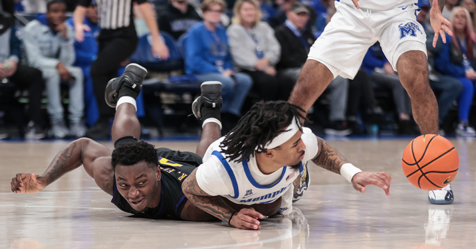 <strong>University of Memphis guard Dante Harris (5) dives for a loose ball against ECU guard RJ Felton (3) during a Jan. 11, 2025 game.</strong> (Patrick Lantrip/The Daily Memphian)