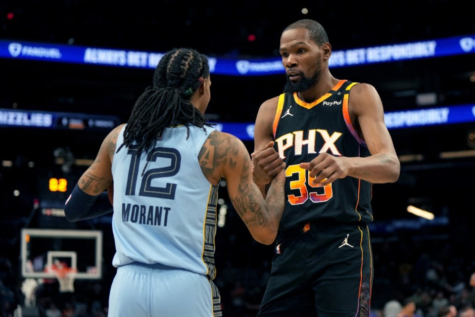 Memphis Grizzlies guard Ja Morant (12) and Phoenix Suns forward Kevin Durant (35) shake hands after the game on Tuesday, Feb. 11, 2025, in Phoenix. Durant became just the eighth player in NBA history to score 30,000 career points. (Rick Scuteri/AP)