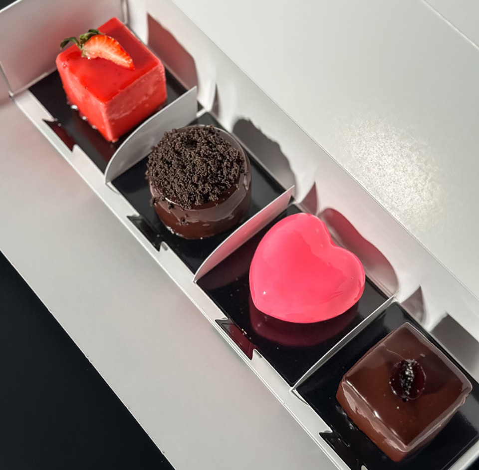 <strong>The 2025 Valentine's Day mini cheesecake collection from Dvour Desserts includes, from left to right, strawberry-rose cheesecake, an Oreo-crusted cherry cheesecake, their classic cheesecake shaped as a heart and their cookies-and-cream cheesecake. (Courtesy Dvour Desserts)</strong>