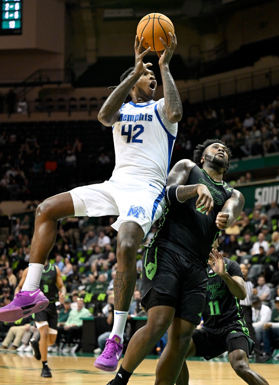 <strong>Memphis forward Dain Dainja (42) is fouled by South Florida forward Jamille Reynolds (2) on Thursday, Feb. 13, 2025, in Tampa, Florida.</strong> (Jason Behnken/AP)