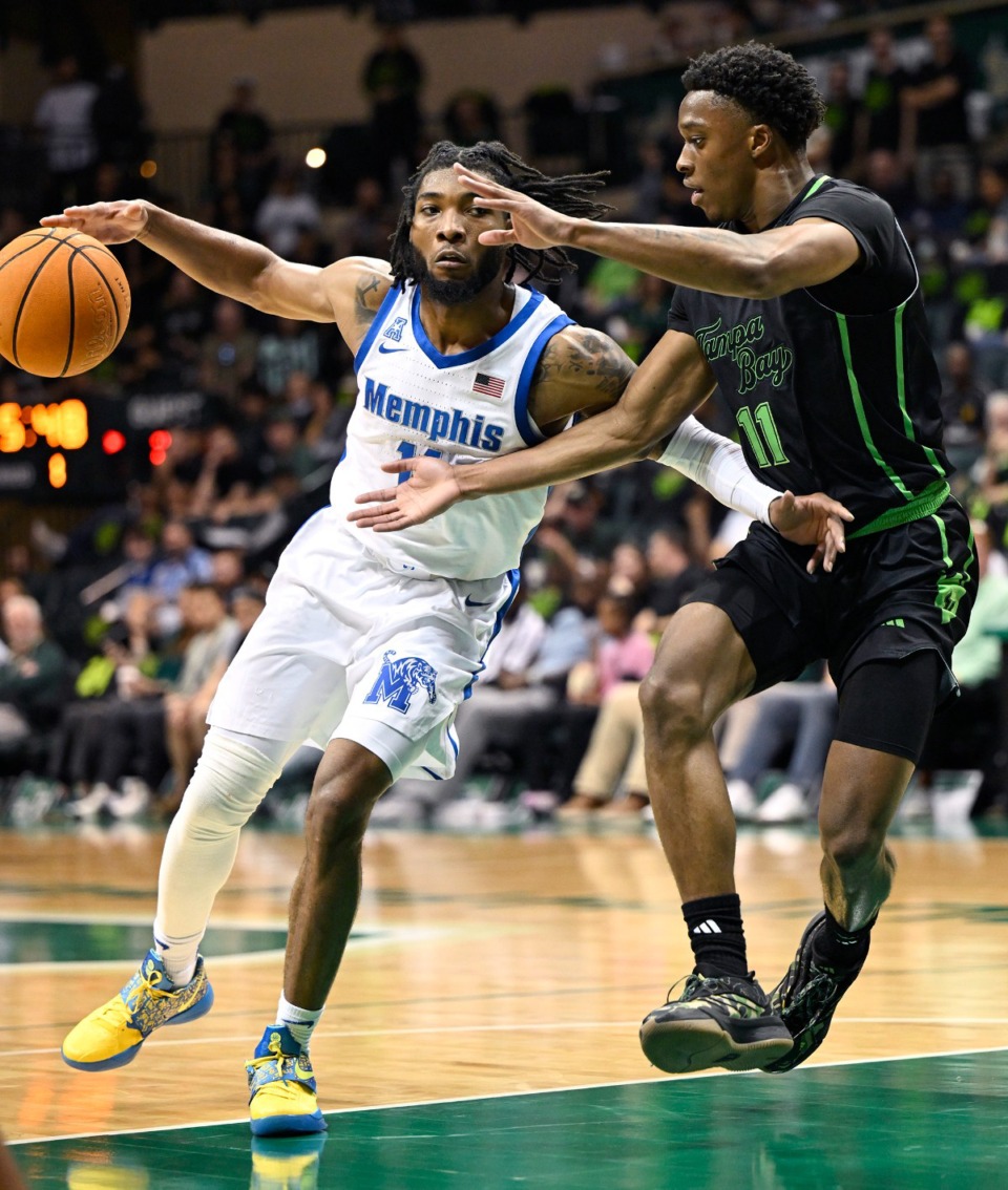 <strong>Memphis guard Tyrese Hunter (11) drives to the basket against South Florida guard CJ Brown (11) during the first half of an NCAA college basketball game Thursday, Feb. 13, 2025, in Tampa, Fla.</strong> (Jason Behnken/AP)