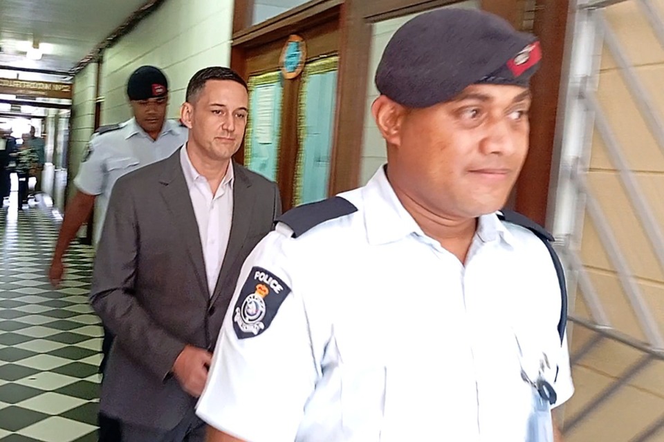 <strong>Bradley Robert Dawson, center, is escorted by police at the High Court in Lautoka, Fiji, on Tuesday, Feb. 11, 2025, before being sentenced to at least 18 years in prison for murdering his wife during their honeymoon in Fiji in 2022.</strong> (Salote Qalubau/The Fiji Times via AP)