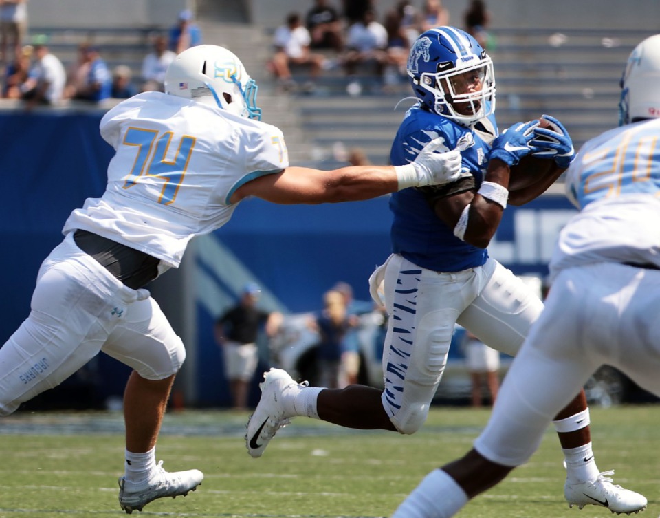 <strong>University of Memphis running back Timothy Taylor (21) dodges a Southern University defender during the fourth quarter of a 55-24 victory over Southern University at Liberty Bowl Memorial Stadium on Saturday, Sept. 7, 2019. </strong>&nbsp;(Patrick Lantrip/Daily Memphian)