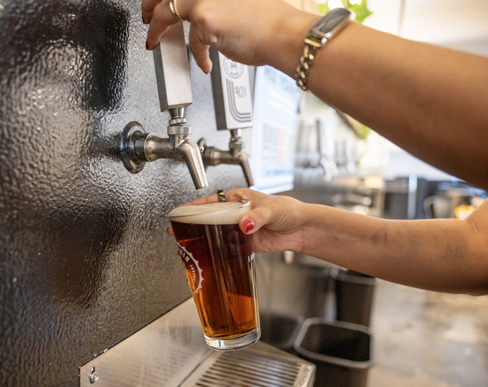 <strong>Leah Castillo pours a Fireside amber ale after the Memphis Made Brewing Co. tour for Michael Weileman in the Tap Room at the brewery.</strong> (Greg Campbell/Special to The Daily Memphian)