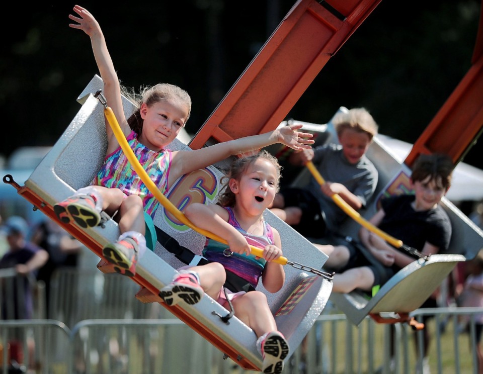 <strong>Sisters Piper (left) and Laney Keathley take a spin on the Ballistic ride during the 48th Germantown Festival on Sept. 7, 2019, at Morgan Woods Park.&nbsp;The annual event features rides, food trucks, over 350 craft booths and the fan favorite Running of the Weenies dog races.</strong>(Jim Weber/Daily Memphian)