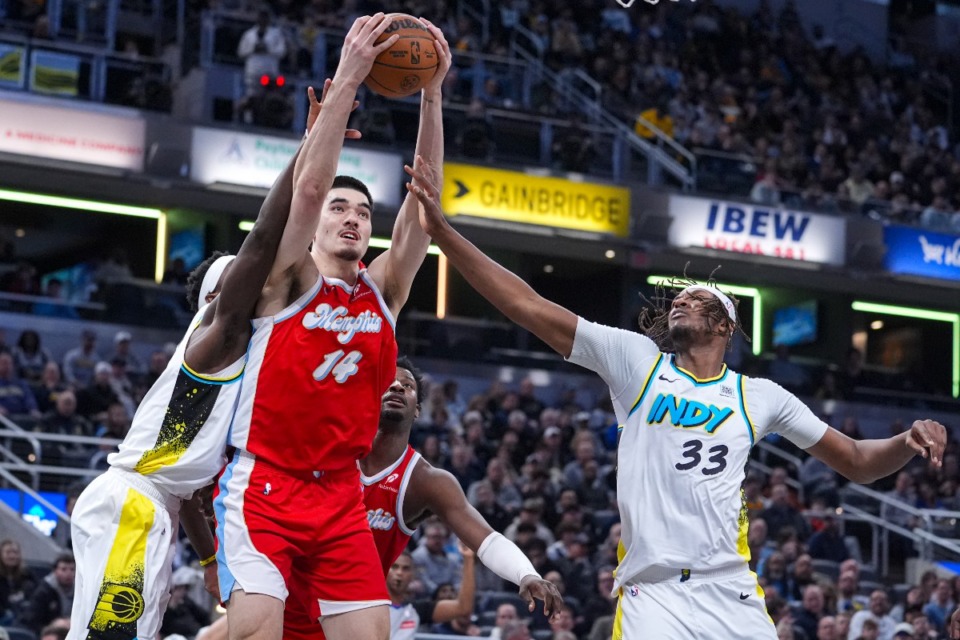 <strong>Memphis Grizzlies center Zach Edey (14) grabs a rebound over Indiana Pacers center Myles Turner (33) in Indianapolis, Thursday, Feb. 20, 2025.</strong> (Michael Conroy/AP)