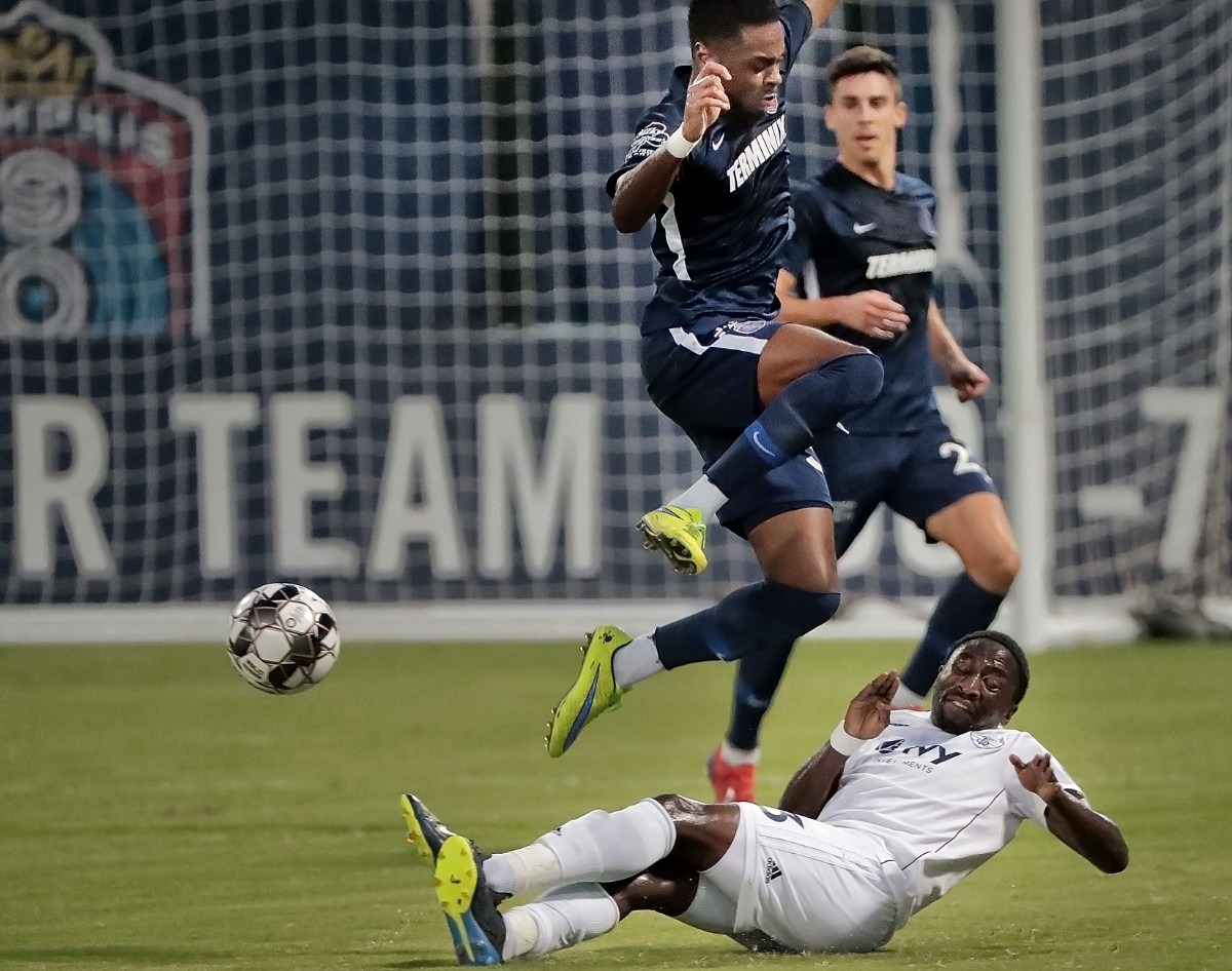 <strong>Memphis midfielder Marcus Epps avoids a collision with the Rangers' Mark Segbers on a sliding steal during 901 FC's 4-2 win over Swope Park at AutoZone Park on Sept. 7, 2019.</strong> (Jim Weber/Daily Memphian)