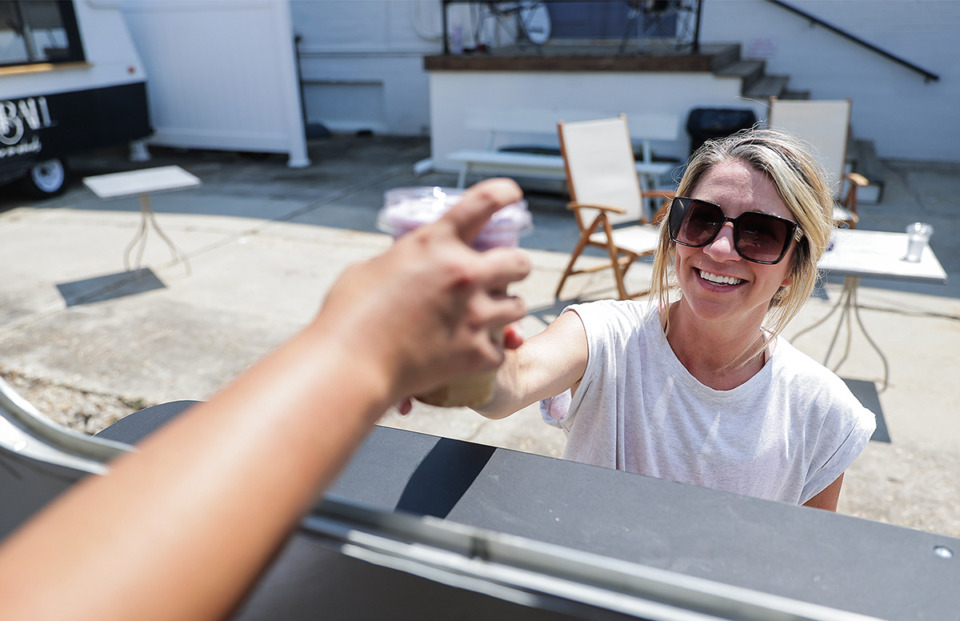 <strong>Avery Amstutz hands Ashley Tinker a Ube Vanilla Cold Foam Latte at Byway Coffee Co.'s new mobile coffee shop July 13, 2024.</strong> (Patrick Lantrip/The Daily Memphian file)