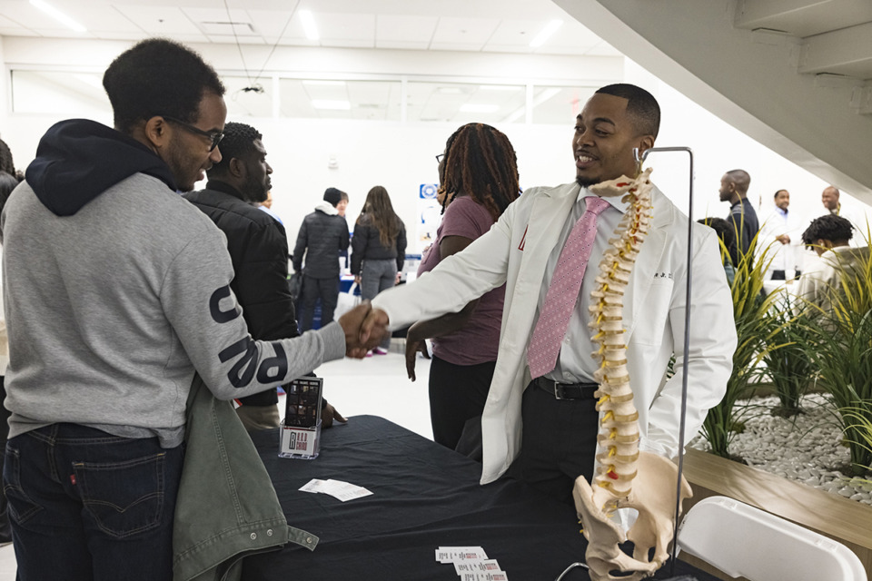 <strong>The annual Black Men in White Coats event provides an opportunity for students to meet medical professionals and learn&nbsp; about career options.&nbsp;Dr. Fred Peete Jr. (right) greeted students including&nbsp; &nbsp;Philip Wofford of Mississippi State.</strong> (Ziggy Mack/Special to The Daily Memphian)