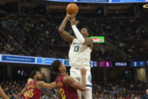 <strong>Memphis Grizzlies' Jaren Jackson Jr. (13) goes up to shoot over Cleveland Cavaliers' De'Andre Hunter (12) as Cavaliers' Donovan Mitchell (45) looks on during the first half of an NBA basketball game in Cleveland, Sunday, Feb. 23, 2025.</strong> (Phil Long/AP Photo)