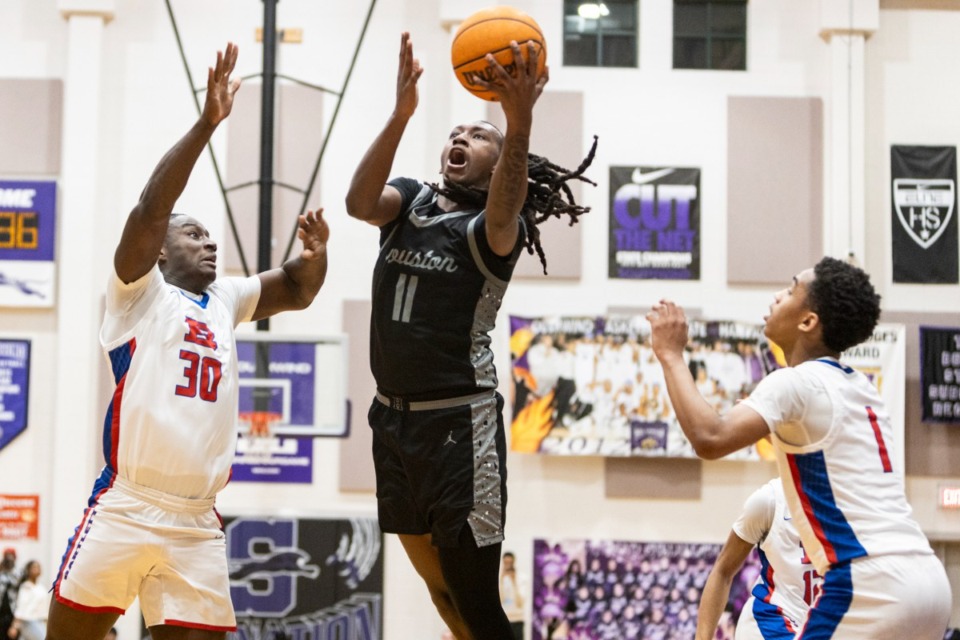 <strong>Houston&rsquo;s Keron Jackson, center, goes up under pressure during Tuesday's District 15-4A title game against Bartlett at Southwind High School.</strong> (Brad Vest/Special to The Daily Memphian)