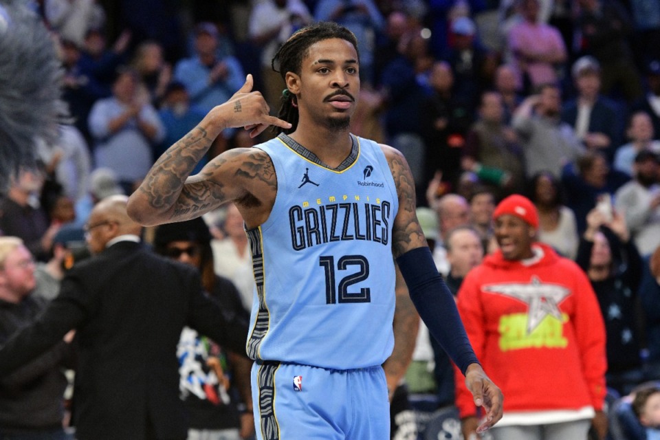 <strong>Memphis guard Ja Morant mimes his famous&nbsp;&ldquo;Call 12&rdquo; after tying the game against Phoenix at the buzzer. The Grizzlies went on to defeat the Suns in overtime.</strong> (Brandon Dill/AP)