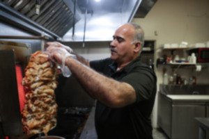 <strong>Abbass Algalgawi prepares a meal at Shawarma King in Cordova on Feb. 25.</strong> (Patrick Lantrip/The Daily Memphian)