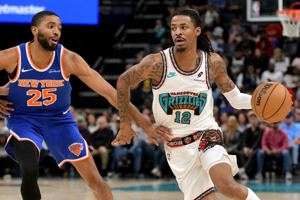 <strong>Memphis Grizzlies guard Ja Morant (12) charges against New York Knicks forward Mikal Bridges (25) on Friday, Feb. 28, 2025.</strong> (Brandon Dill/AP)