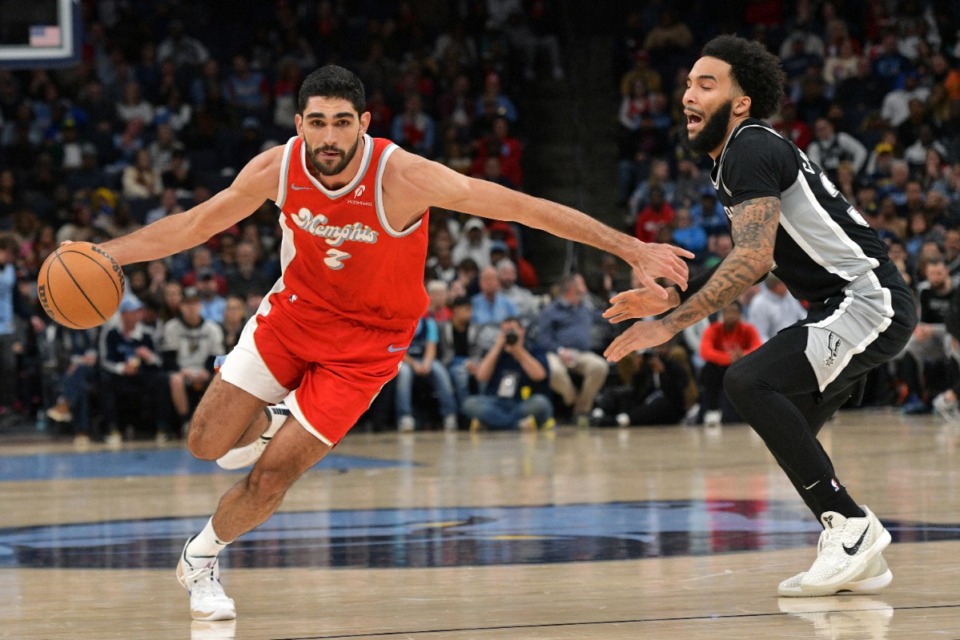 <strong>Memphis Grizzlies forward Santi Aldama (7) handles the ball ahead of San Antonio Spurs forward Julian Champagnie in the second half of an NBA basketball game Saturday, March 1 at FedExForum.</strong> (Brandon Dill/AP)