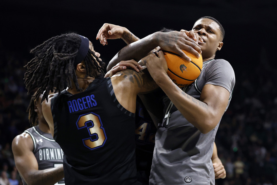 <strong>UAB forward Christian Coleman and Memphis guard Colby Rogers (3) battle for a rebound during the second half of an NCAA college basketball game, Sunday, March 2, 2025, in Birmingham, Ala.</strong> (Butch Dill/AP Photo)