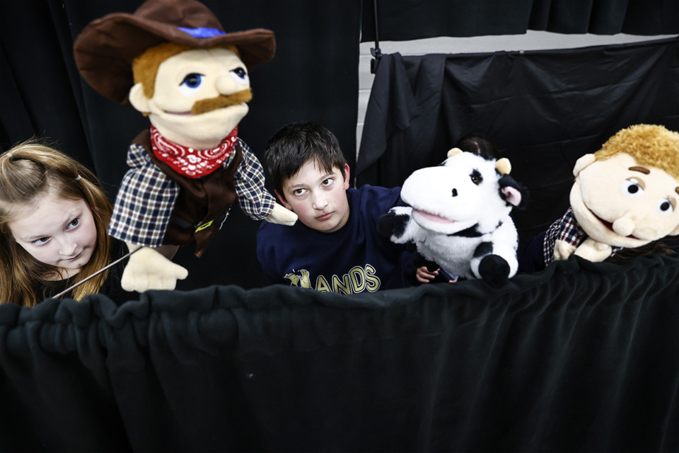 <strong>Arlington Elementary School fifth grader Clara Hanson (left) performs with classmate Mack Phillips (right) during a puppetry club practice on Monday, Feb. 24, 2025.</strong> (Mark Weber/The Daily Memphian)