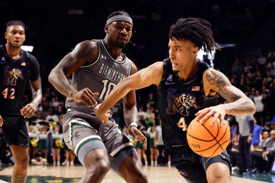 <strong>Memphis guard PJ Haggerty (4) drives to the basket around UAB guard Alejandro Vasquez during the first half of an NCAA college basketball game, Sunday, March 2, 2025, in Birmingham, Ala.</strong> (Butch Dill/AP Photo)