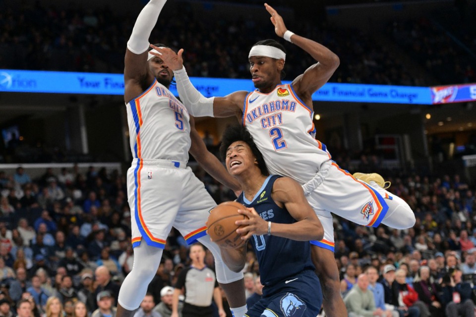 <strong>Memphis Grizzlies forward Jaylen Wells (0) is smothered by Oklahoma City Thunder guards Shai Gilgeous-Alexander (2) and Luguentz Dort (5) on Wednesday, March 5, 2025.</strong> (Brandon Dill/AP)