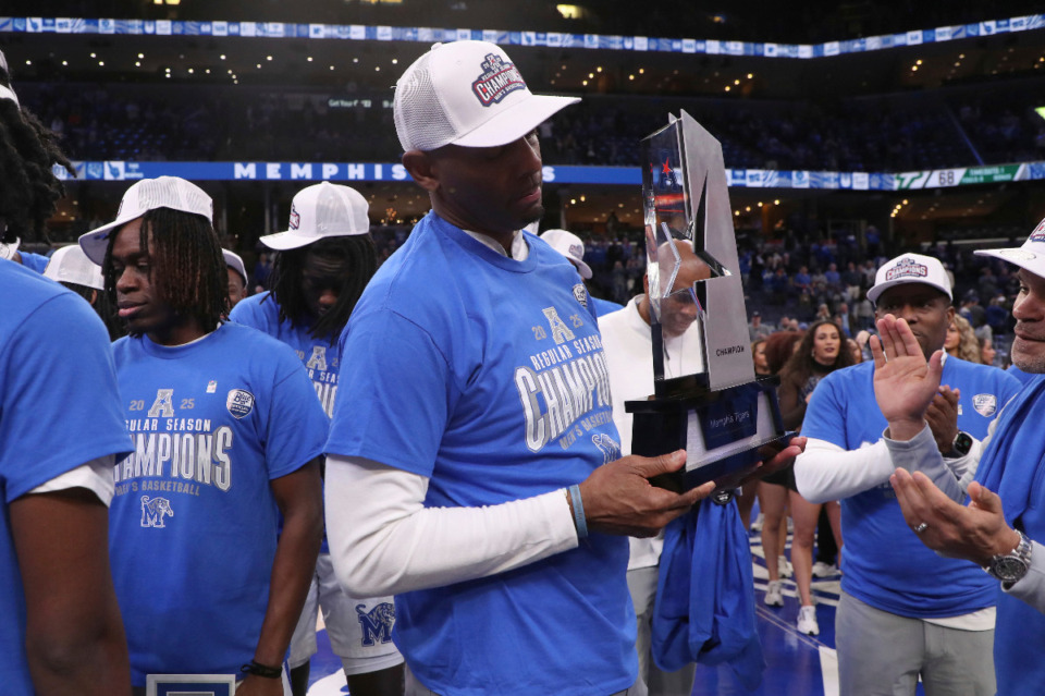 <strong>Memphis head coach Penny Hardaway is presented with the championship trophy as the team claims the American Athletic Conference regular season championship following an NCAA college basketball game against South Florida, Friday, March 7, 2025, in Memphis, Tenn.</strong> (AP Photo/Nikki Boertman)