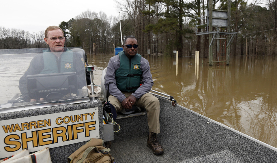 <strong>Mayors of cities and towns along the Mississippi River have experienced increased flooding, heavier rainfall and more frequent droughts in recent years. Warren County Sheriff Martin Pace, left, and Warren County Sheriff&rsquo;s Department Detective Samuel Winchester, right, use a boat to patrol the Yazoo River flooded Chickasaw subdivision in Vicksburg, Miss., Friday, March 1, 2019. Vicksburg Mayor George Flaggs Jr. is co-chair of the Mississippi River Cities and Towns Initiative, a nonprofit organization advocating for town and city leaders.</strong> (Rogelio V. Solis/AP Photo file)